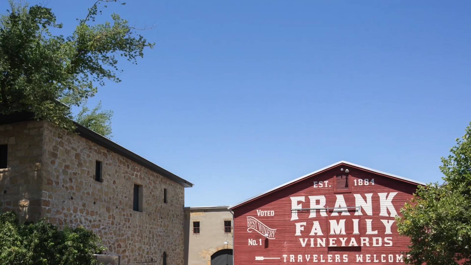 The stone winery building and the red barn at Frank Family Vineyards on Larkmead Lane in Calistoga. The collaborative bottle makes its debut at a fashion show and luncheon on the property on Oct. 24.
