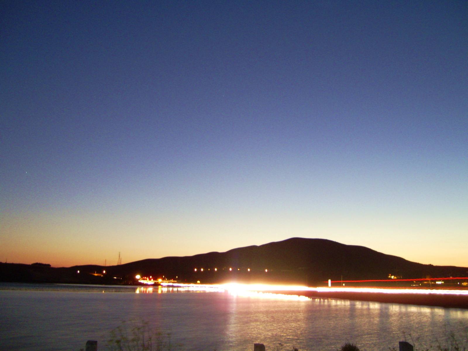 Highway 37 at dusk below Raceway Hill at Sears Point, the western end of the stretch Caltrans will close Oct. 23 to 26. Traffic will be shifted onto the westbound lanes while crews raise the eastbound side.