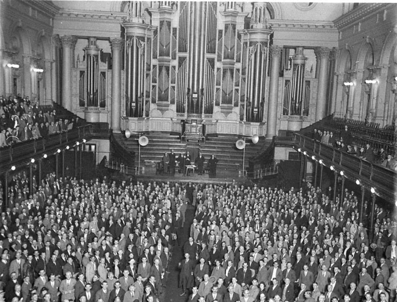 A packed town hall in Sydney, in a historic photograph; Tuesday's forum covers the county's annual report on immigration enforcement access.