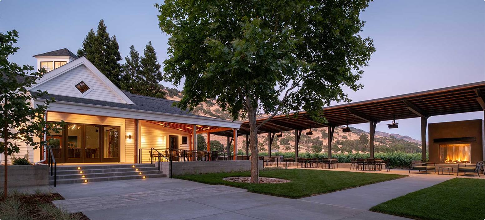 The Estate House terrace at Duckhorn Vineyards glows at dusk in St. Helena.
