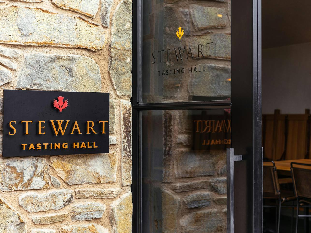The Stewart Tasting Hall sign at the entrance of Stewart Cellars' Yountville tasting room.