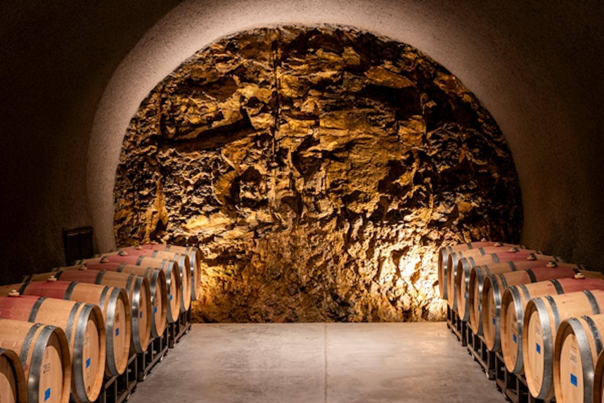 Barrel rows inside the rock-walled cave cellar at O'Shaughnessy Estate Winery on Howell Mountain.