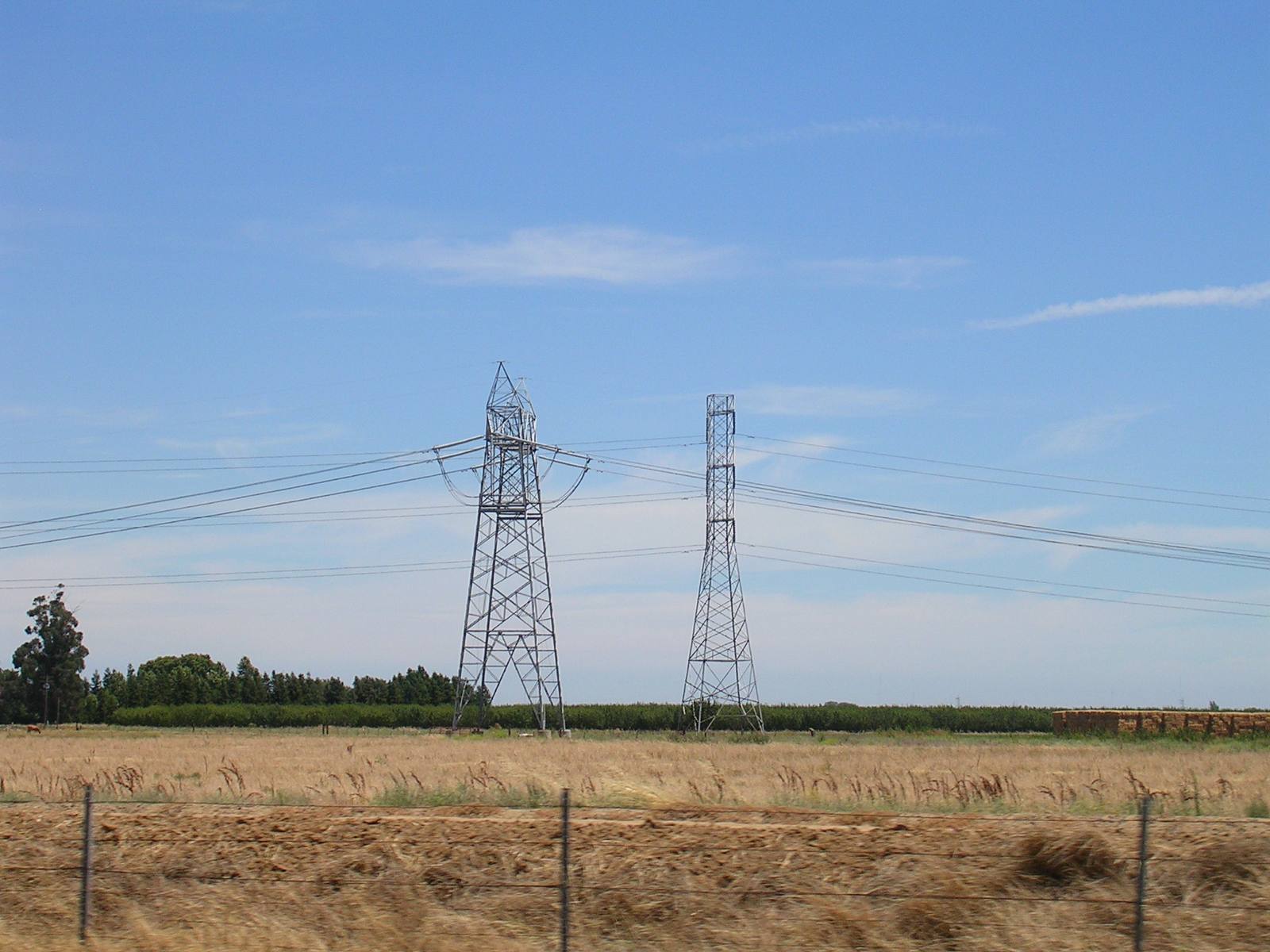 A single-circuit PG&E 500 kV line runs beside a dual-circuit 230 kV line as the larger line leaves the Vaca-Dixon substation near Vacaville. PG&E says it turns power off proactively when severe weather puts lives and property in danger of wildfire.