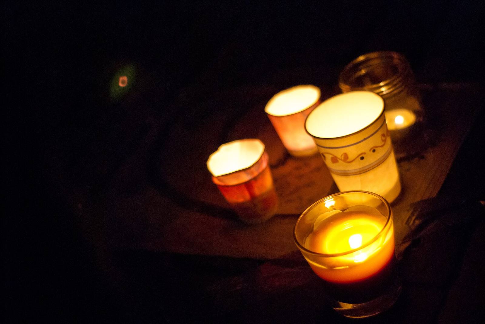 Candles burn at a community vigil. The Oct. 17 program runs from 3 to 8 p.m. and closes with a candlelight vigil on the softball fields.